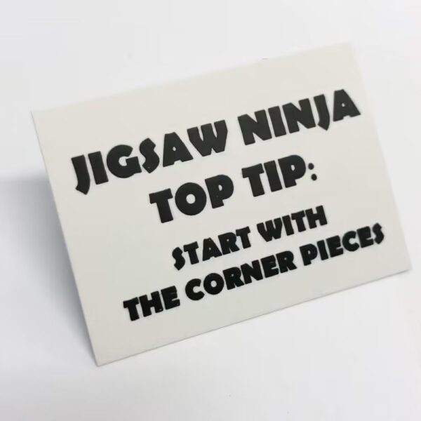 Jigsaw Ninja top tip card featuring humorous advice: 'Start with the corner pieces.' A playful part of the One Million Piece Jigsaw Puzzle set.