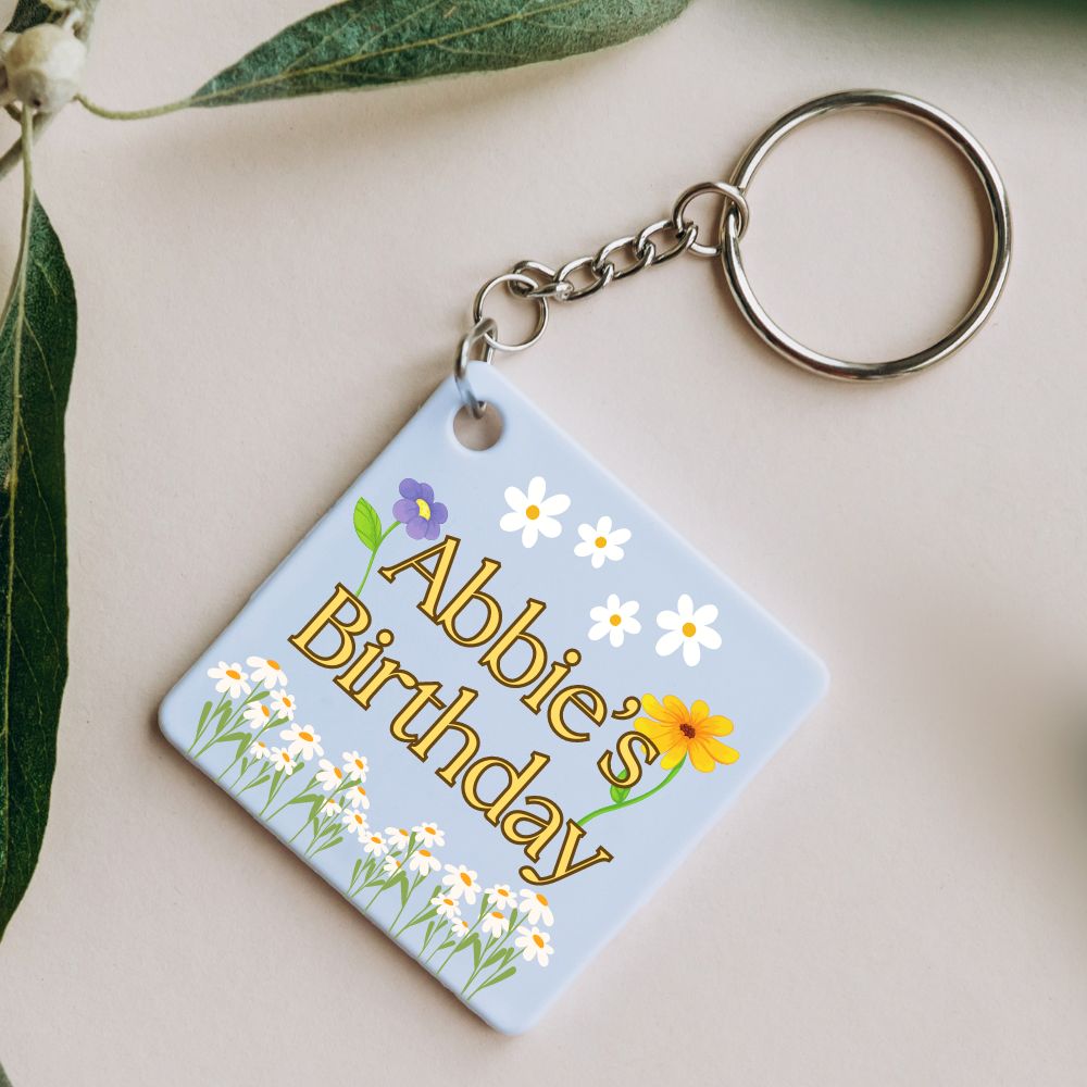 Small personalised keyring party favour with 'Abbie's Birthday' text, a perfect flat item to include with party invitations for a memorable touch.