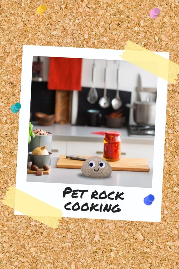 A pet rock with googly eyes and a smile on a kitchen counter next to a cutting board and cooking ingredients.