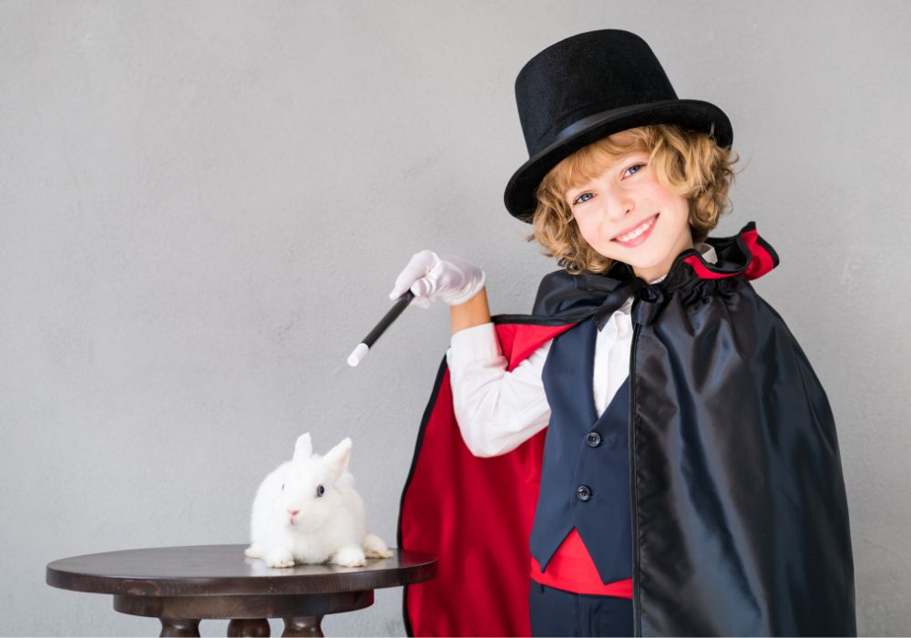 A child dressed as a magician with a magic wand, ready to perform for a virtual talent show.